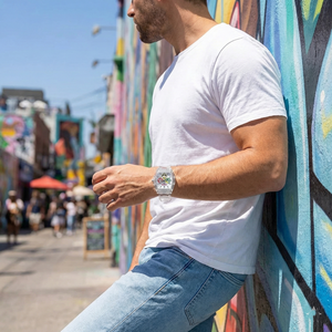 Model wearing Guess V1051M1 clear watch with a colorful streetwear outfit
