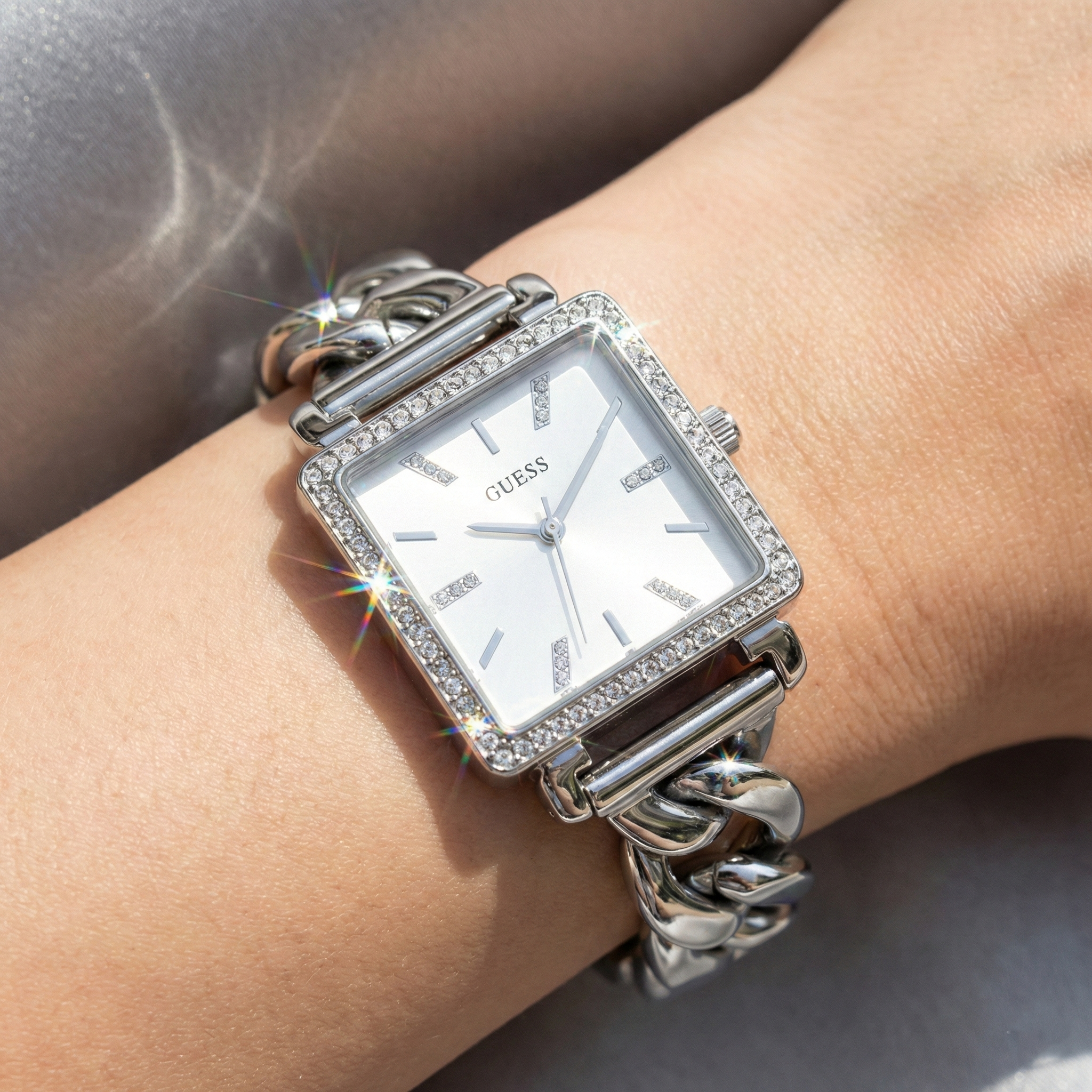 Close up shot of Guess Vanity W1030L1 watch on wrist showing the square dial and crystal details