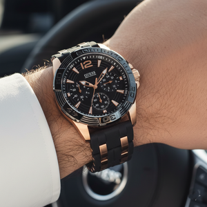 Close up shot of Guess W0366G3 on wrist highlighting the black dial and gold accents