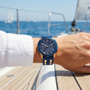 Male model wearing Guess W0366G4 blue and rose gold watch with a smart casual outfit