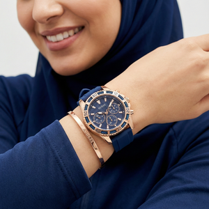 AI lifestyle shot of a woman wearing Guess Catalina W0562L3 blue rubber watch