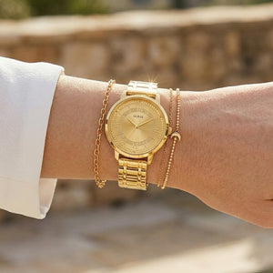 Close up shot of Guess W0933L2 on wrist showing the shimmering gold glitter dial and gold-tone hands