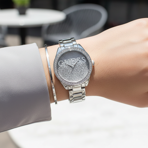 Female model wearing Guess W0987L1 silver glitter watch with an evening party outfit