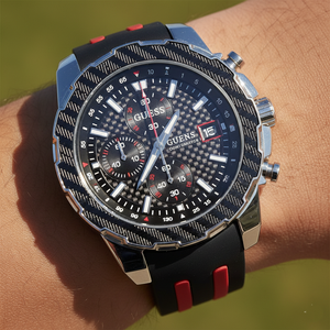 Close up shot of Guess W1047G1 on wrist highlighting the carbon fiber look dial and red accents