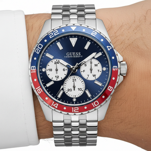 Close up shot of Guess W1107G2 on wrist highlighting the blue dial and red-blue bezel