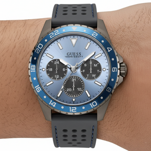 Close up shot of Guess W1108G6 on wrist highlighting the sky blue sunray dial and blue bezel