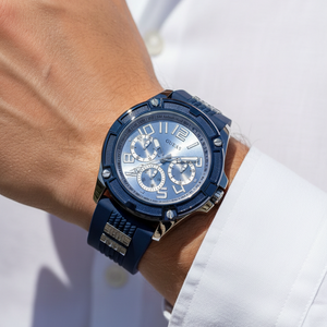 Guess Rig GW0051G4 men's watch with silver case, blue bezel, and blue rubber strap with metal inserts