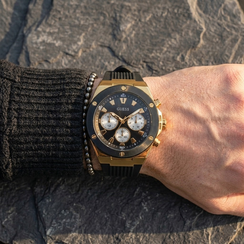 Close up of Guess Poseidon GW0057G1 men's quartz battery watch on wrist showing deep black dial and luxury black bezel