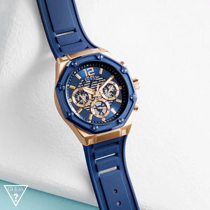 Live photo of Guess Momentum GW0263G2 men's quartz battery watch showing actual rose gold finish and deep blue dial