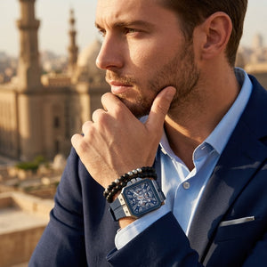 Elegant man wearing Guess LEO GW0637G1 men's quartz battery watch with silver case and luxury crystal animal print strap