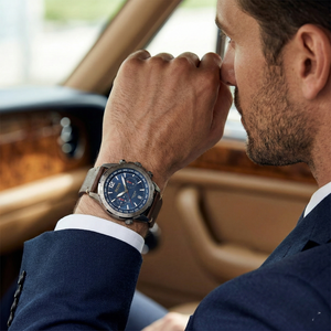 Man wearing Hugo Boss 1513773 gray and blue watch with brown leather strap for a rugged, sophisticated look