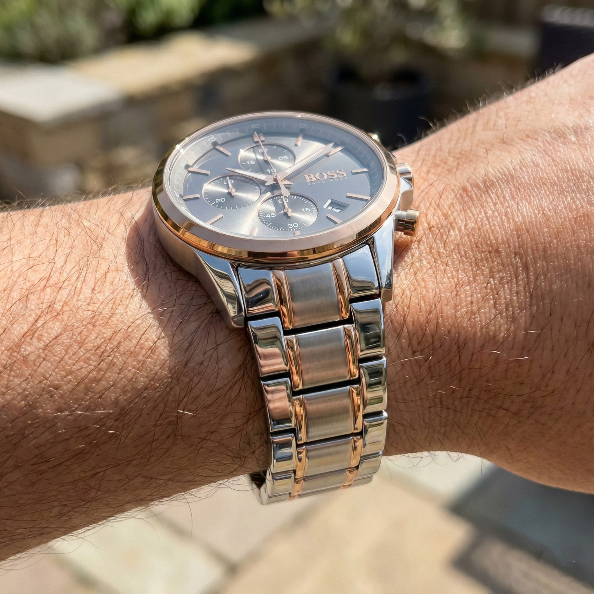 Close up shot of Hugo Boss Steer 1514252 on wrist showing the grey sunray dial reflection and rose gold details