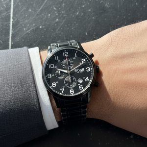 Close up shot of Hugo Boss Aeroliner 1513180 watch on wrist showing the black dial and white Arabic numerals