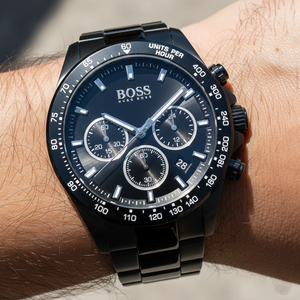 Close up shot of Hugo Boss Hero Sport 1513754 watch on wrist showing the black dial and tachymeter bezel