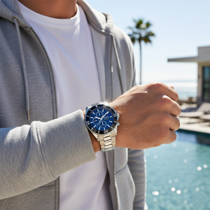 Male model wearing Hugo Boss Ocean Edition 1513704 silver watch with a sporty outfit
