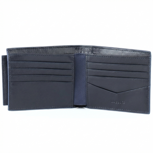 Fully open interior view of a Lacoste men's navy blue leather wallet featuring multiple card slots, bill compartments, and debossed branding