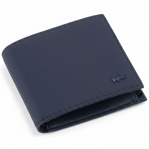 Perspective view of a standing semi-open Lacoste men's navy blue textured leather bifold wallet showcasing the matching tonal navy crocodile logo