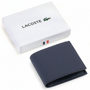 A closed Lacoste men's navy blue textured leather wallet featuring a tonal crocodile logo, placed elegantly next to its matching closed white branded gift box