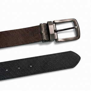 Detailed close-up of the Levi's gunmetal plaque buckle featuring the precision-engraved two-horse pull heritage logo