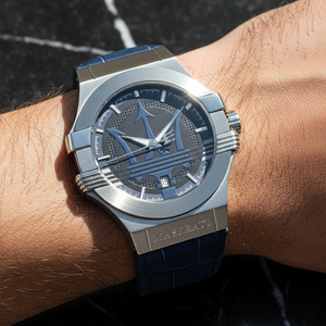 Close up shot of Maserati Potenza R8851108015 watch on wrist showing the blue dial and large Trident logo