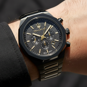 Close up shot of Maserati Stile R8873642005 on wrist showing the black textured dial and gold trident