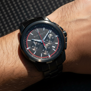 Close up shot of Maserati Successo R8873621014 watch on wrist showing the black dial and red hands