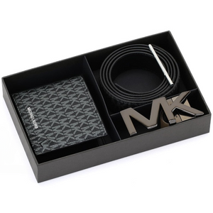 Top-down view of a Michael Kors men's black gift set inside its presentation box, featuring a monogram wallet, coiled reversible belt, rotating MK buckle, and sizing tool