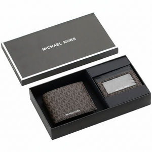 Top-down view of a Michael Kors men's brown MK patterned wallet and matching cardholder securely displayed inside an open black branded gift box