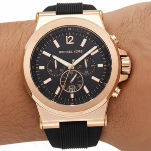 Close up of the MK8184 black dial showing rose gold-tone indices, sub-dials, and numerical 12