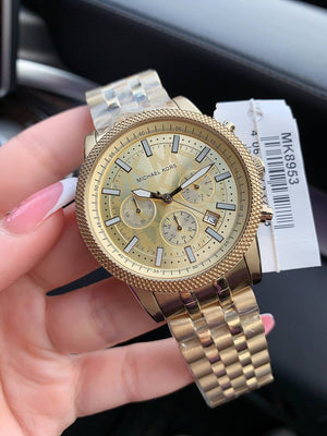 Extreme close-up of the premium brushed and polished gold-tone finish on the MK8953 case