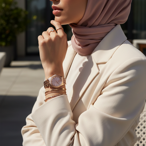 Woman wearing Michael Kors Lexington Mini rose gold watch styled with elegant feminine jewelry