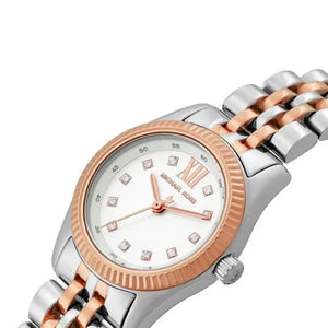 Extreme close-up of Michael Kors MK4817 rose gold fluted bezel and polished crown