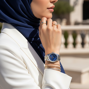 Woman wearing Michael Kors Lexington Mini two-tone watch with navy dial for an elegant evening look