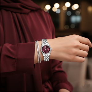 Modest woman wearing Michael Kors MK4968 silver watch with burgundy dial on hairless wrist
