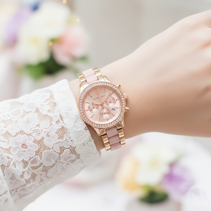 Feminine woman wearing Michael Kors MK6307 rose gold and pink watch on smooth hairless wrist