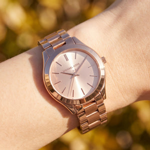 Close up shot of Michael Kors MK3513 on wrist showing rose gold dial and polished indices
