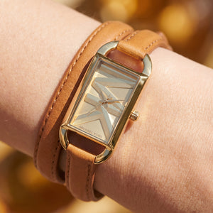 Close up shot of Michael Kors MK4721 on wrist showing gold dial and double wrap brown leather strap