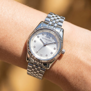 Close up shot of Michael Kors MK4843 on wrist showing silver dial and crystal markers