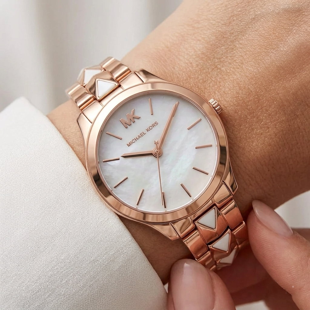 Close up of Michael Kors Runway MK6671 on wrist showing mother of pearl dial and unique pyramid shell inlay bracelet