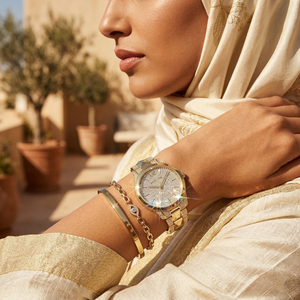 Elegant woman wearing Michael Kors Runway Mercer MK6715 with gold-tone case and brilliant pavé dial luxury style watch