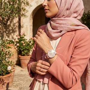 Elegant woman wearing Michael Kors Runway MK6854 women's quartz battery watch with rose gold-tone case and brilliant pavé dial