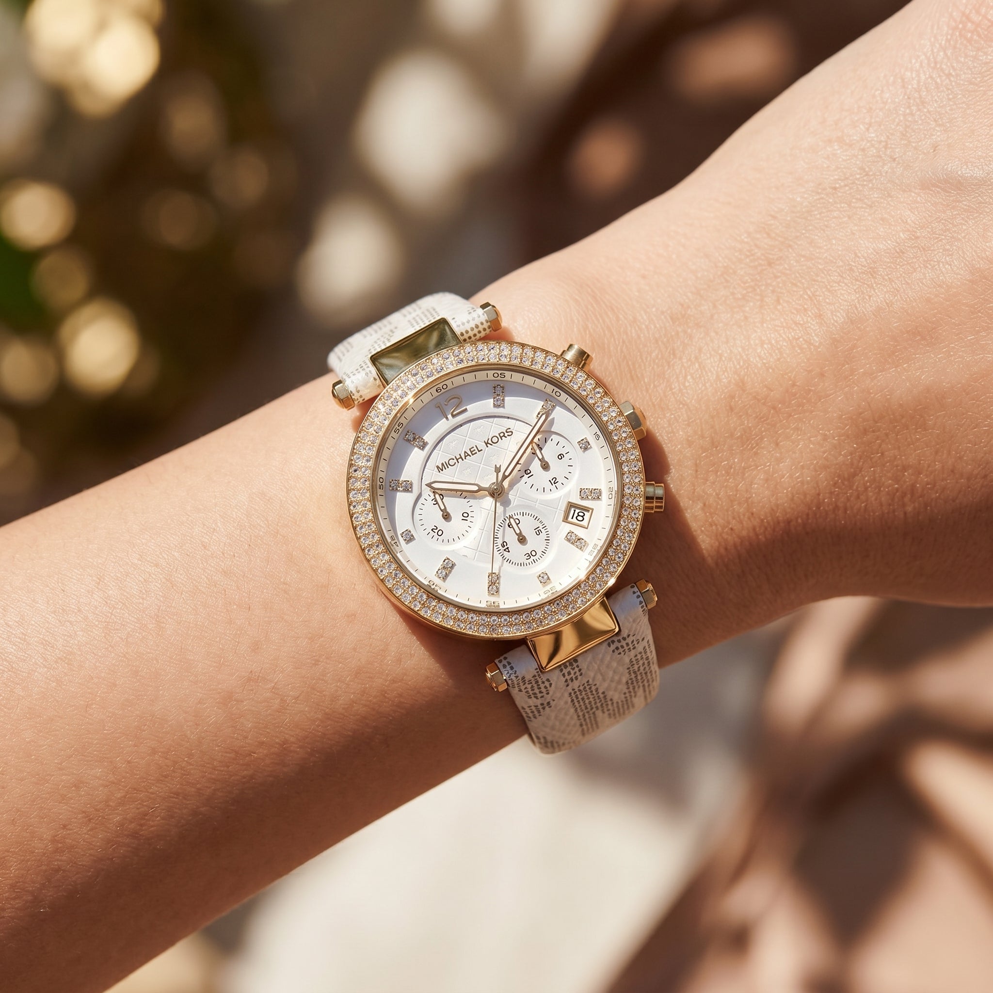 Close up shot of Michael Kors MK6916 on wrist showing white dial and dual-row crystal bezel