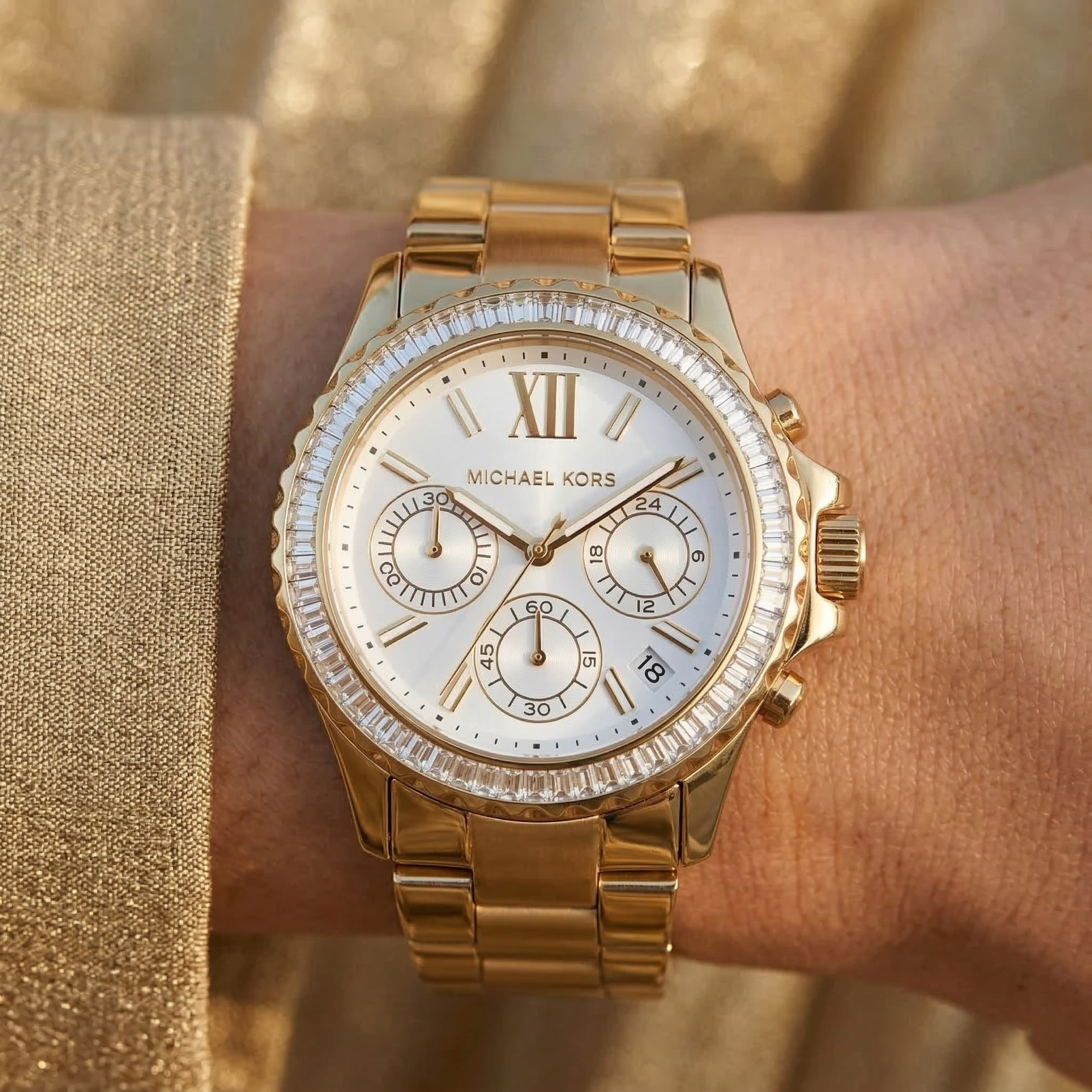 Close up of Michael Kors Everest MK7212 women's quartz battery watch on wrist showing white dial and brilliant crystal bezel