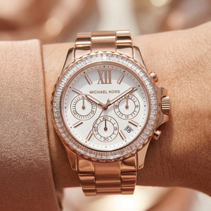 Close up of Michael Kors Everest MK7213 women's quartz battery watch on wrist showing white dial and brilliant crystal bezel