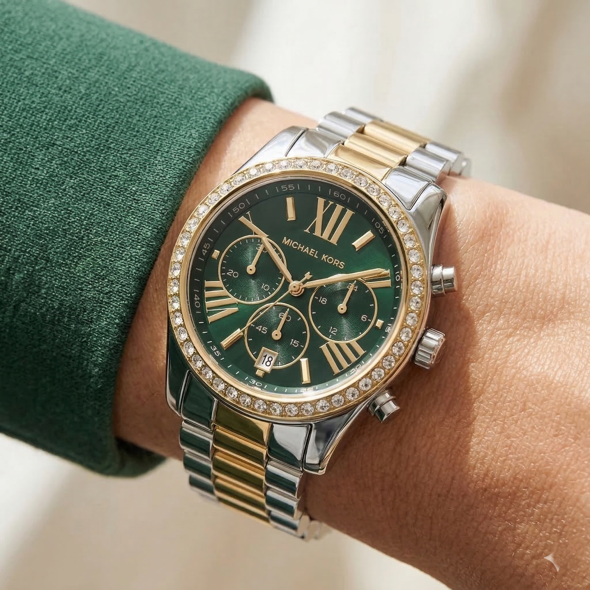 Elegant woman wearing Michael Kors Lexington MK7303 women's quartz battery watch with two-tone case and luxury green dial