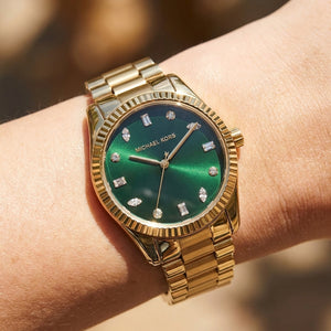 Close up shot of Michael Kors MK7449 on wrist showing green dial and multi-shaped crystal markers