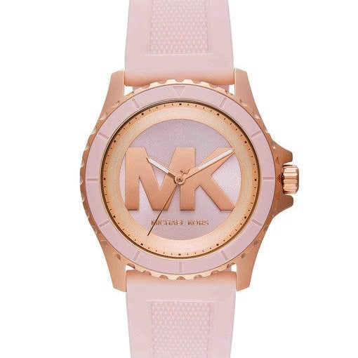 MK7536 Michael Kors analog watch with a light pink textured silicone strap, a rose gold-tone case, and a matching rose gold dial featuring a large 'MK' logo.