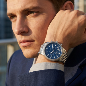 Elegant man wearing Michael Kors Hutton MK8952 men's quartz battery watch with silver-tone case and unique knurled bezel