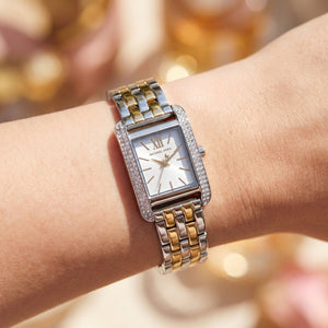 Close up shot of Michael Kors MKO1035 on wrist showing the silver and gold case with white dial
