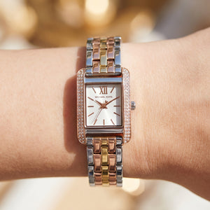 Close up shot of Michael Kors mko1146 on wrist showing white dial and rose gold-tone Roman numerals